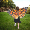 Small girl wearing Dress Up Painted Lady Butterfly Wings running through backyard