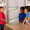 Three children in a home setting looking into a Butterfly Pavilion butterfly habitat