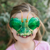 Small girl wearing green Praying Mantis style plastic googles