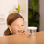 Little girl excitedly looking into a Cup of 5 Baby Caterpillars in home setting
